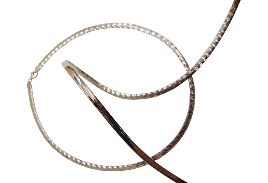 9k WG Italian Double Sided Plain and Swiss Cut Omega Chain 5mm wide 50cm  Approx 23.4g  This is an evening piece not suitable for everyday wear. To prevent damage, chain should be stored flat in a protective box.