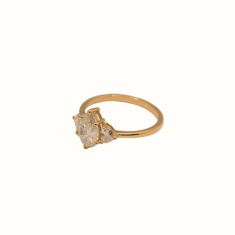 18k YG Diamond Ladies Engagement ring.  Claw Set with 1 x Pear Diamond = 1.05ct, Colour G Clarity SI2. GIA Certificate no. 7526711604 and 2 x Heart Shape Diamonds set on either side of ring = 0.25ct.  Size M