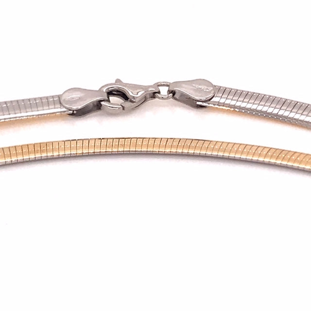 9k YG Italian Double Sided Plain with WG Rhodium Plating on one side Omega Chain 5mm Wide 42cm  Approx 18.3g  This is an evening piece not suitable for everyday wear. To prevent damage, chain should be stored flat in a protective box.