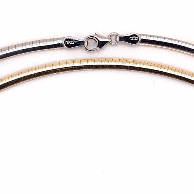 9k YG Italian Double Sided Plain with WG Rhodium Plating on one side Omega Chain 3mm Wide 50cm  Approx 12.6g. This is an evening piece not suitable for everyday wear. To prevent damage, chain should be stored flat in a protective box.