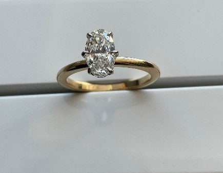 18k Yellow Gold Solitare Band with 18k White Gold Setting and Natural Diamonds on under bezel of setting. Centre stone unset to suit an Oval Diamond Measuring 8.96 - 5.45 * 3.31. Size N.
